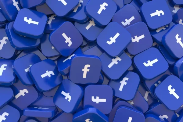 Imagem de vários ícones azuis 3D, empilhados de forma aleatória, com o símbolo do Facebook.